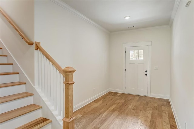 foyer featuring crown molding and light wood-type flooring