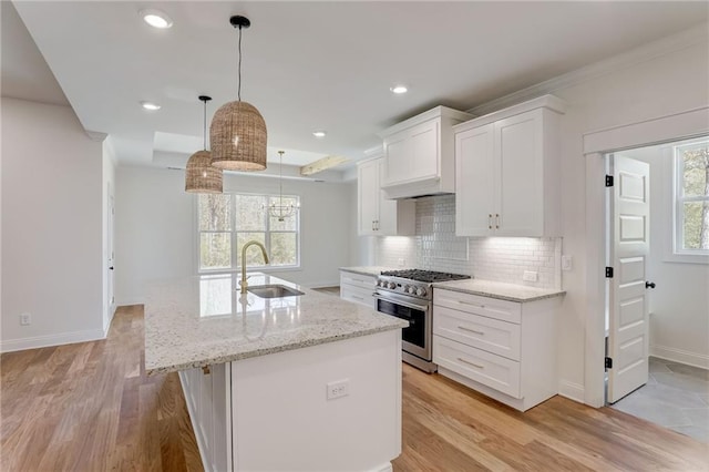 kitchen featuring white cabinetry, light hardwood / wood-style floors, sink, and high end stove