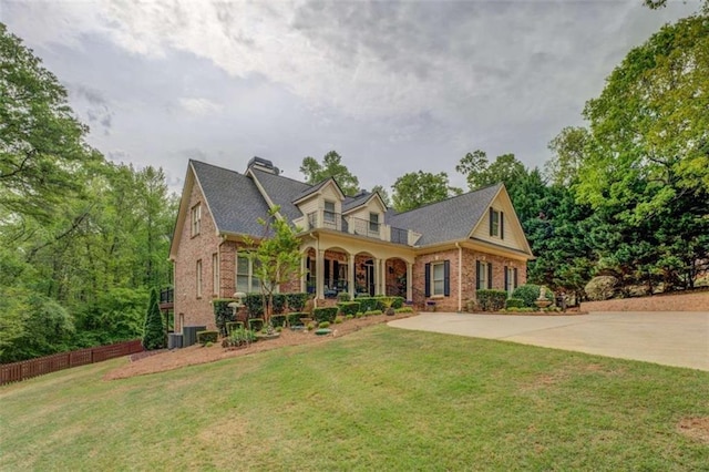 95 Weslyan Way, Oxford, GA 30054 - cape cod-style house with brick siding, a front yard, a chimney, and a porch