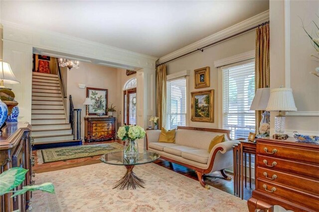 95 Weslyan Way, Oxford, GA 30054 - living area with crown molding, stairway, wood finished floors, and a chandelier