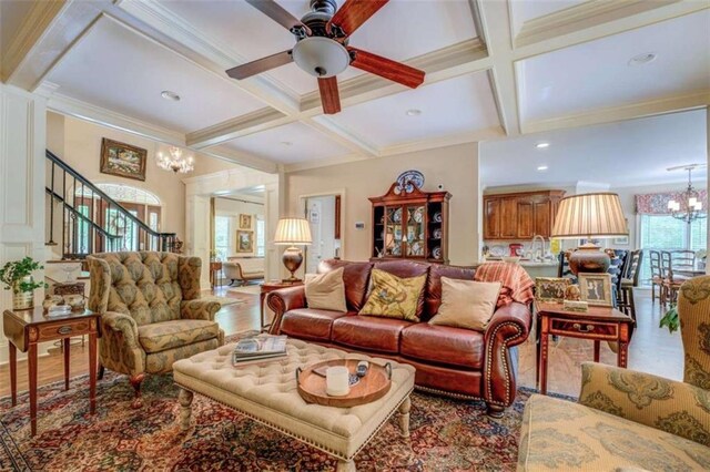 95 Weslyan Way, Oxford, GA 30054 - living area featuring coffered ceiling, stairs, beamed ceiling, a chandelier, and ceiling fan