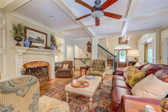 95 Weslyan Way, Oxford, GA 30054 - living area featuring wood finished floors, coffered ceiling, ceiling fan, beamed ceiling, and crown molding