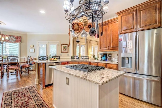 95 Weslyan Way, Oxford, GA 30054 - kitchen featuring stainless steel appliances, a chandelier, a peninsula, light stone counters, and a kitchen island