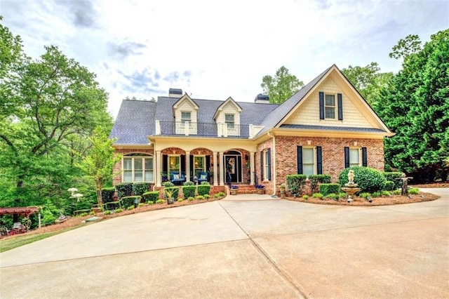 95 Weslyan Way, Oxford, GA 30054 - view of front facade with covered porch, brick siding, a balcony, and concrete driveway