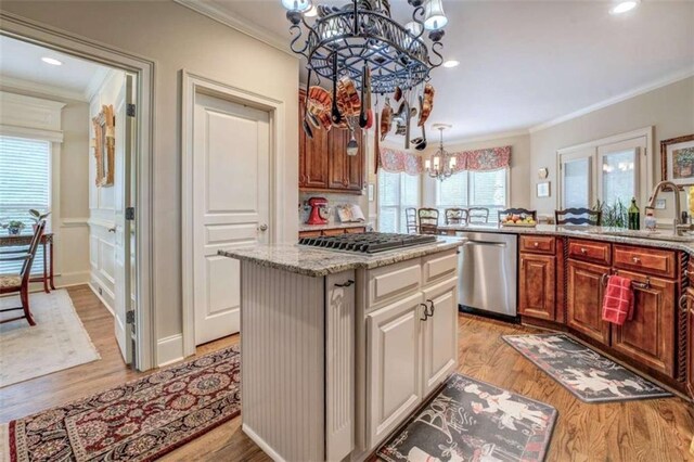 95 Weslyan Way, Oxford, GA 30054 - kitchen featuring appliances with stainless steel finishes, a chandelier, a sink, ornamental molding, and light wood-type flooring