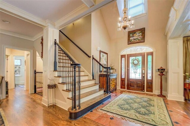 95 Weslyan Way, Oxford, GA 30054 - foyer entrance featuring healthy amount of natural light, wood finished floors, stairs, a chandelier, and a towering ceiling
