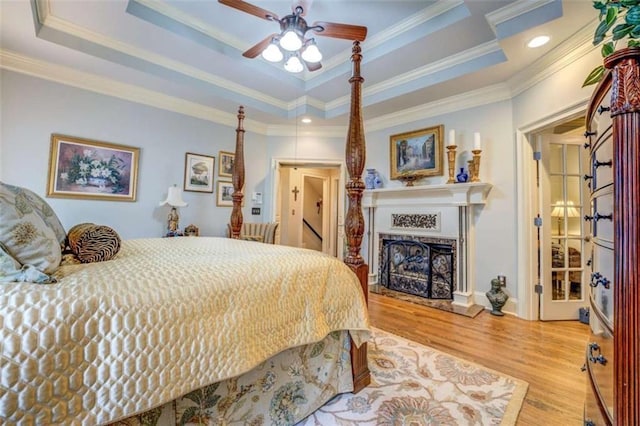 95 Weslyan Way, Oxford, GA 30054 - bedroom with a raised ceiling, wood finished floors, a fireplace with raised hearth, ornamental molding, and recessed lighting