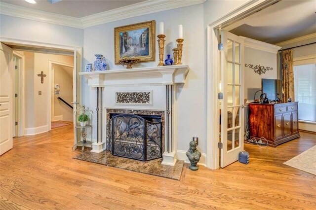 95 Weslyan Way, Oxford, GA 30054 - living area with wood finished floors, crown molding, a high end fireplace, and baseboards