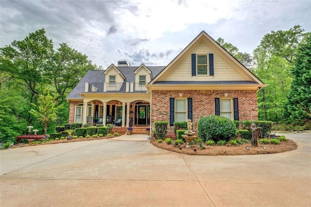 95 Weslyan Way, Oxford, GA 30054 - view of front of house with a porch, brick siding, a balcony, and a chimney