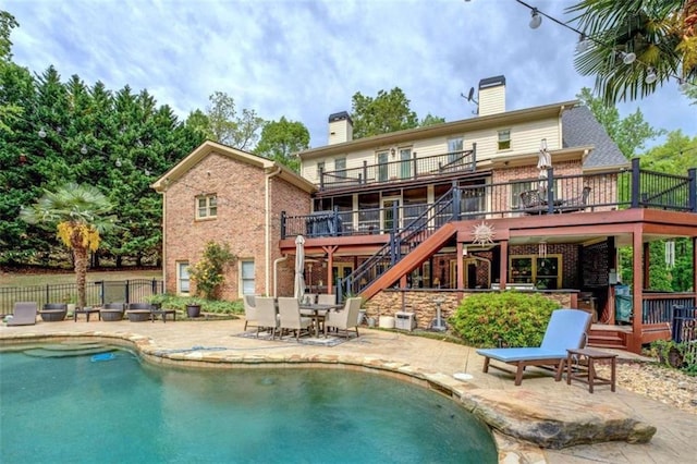 95 Weslyan Way, Oxford, GA 30054 - rear view of house featuring a chimney, a wooden deck, stairs, and brick siding