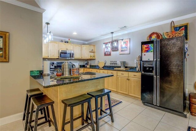95 Weslyan Way, Oxford, GA 30054 - kitchen with stainless steel microwave, black fridge, light brown cabinetry, a peninsula, and crown molding