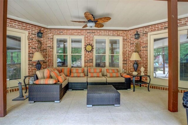 95 Weslyan Way, Oxford, GA 30054 - living area with ornamental molding, plenty of natural light, a ceiling fan, and brick wall