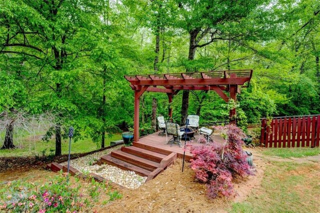 95 Weslyan Way, Oxford, GA 30054 - view of yard featuring a wooden deck, a pergola, and a forest view