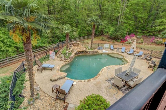 95 Weslyan Way, Oxford, GA 30054 - view of swimming pool featuring a patio, a fenced backyard, and a wooded view