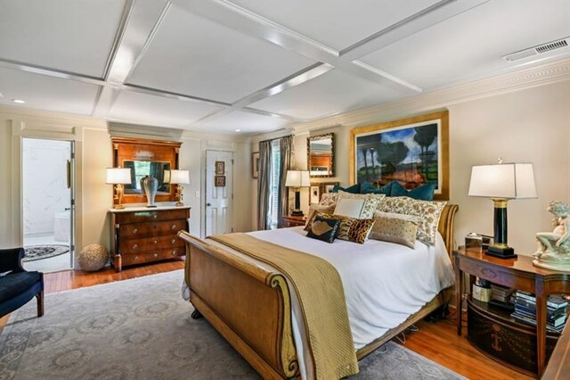 bedroom featuring wood finished floors and coffered ceiling