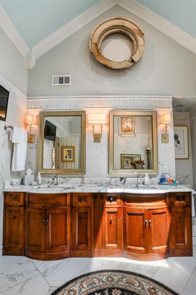 full bath with plenty of natural light and a marble finish shower
