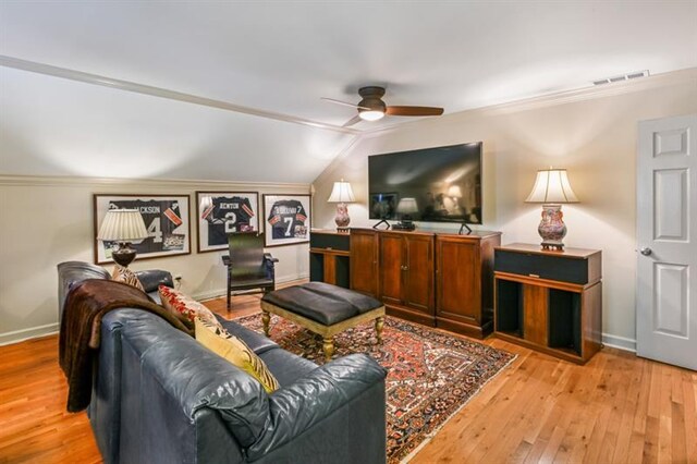 living area with light wood-type flooring, ornamental molding, and ceiling fan