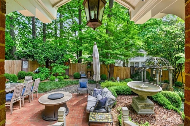 view of patio / terrace with a fenced backyard and an outdoor fire pit