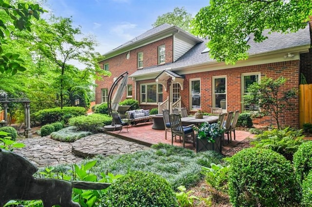 back of house featuring a patio and brick siding