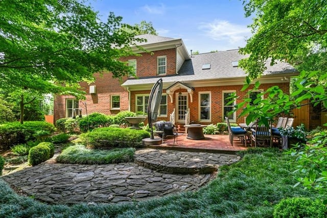 back of house featuring a patio and brick siding