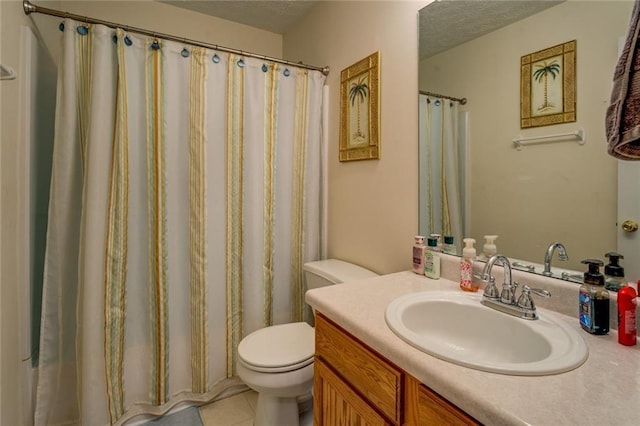 bathroom with toilet, tile patterned flooring, vanity, and a textured ceiling