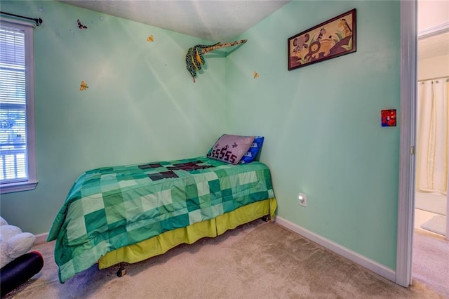 bedroom with baseboards, multiple windows, and carpet