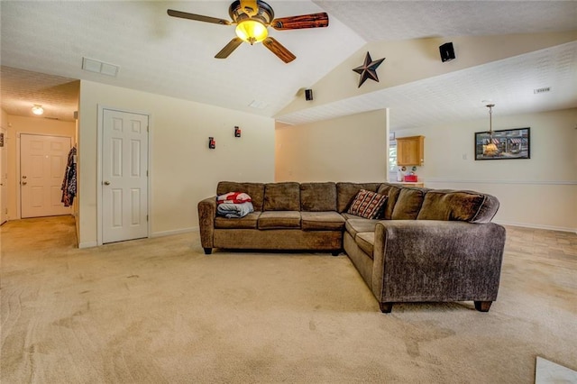 living room with lofted ceiling, baseboards, ceiling fan, visible vents, and light carpet