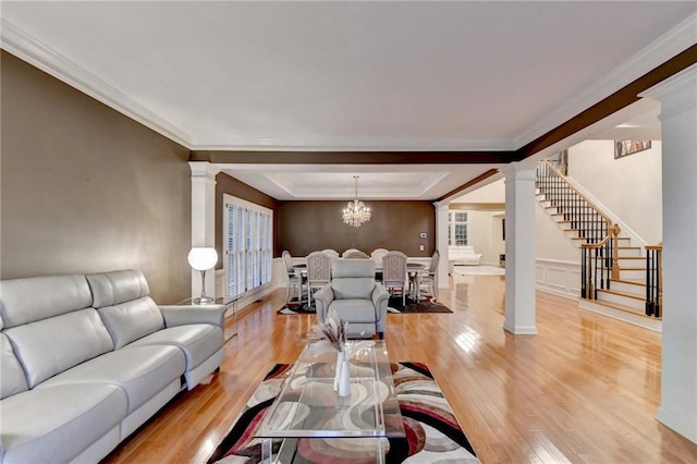 3565 Hickory Branch Trl, Suwanee, GA 30024 - living area with ornate columns, light wood-type flooring, stairway, ornamental molding, and a raised ceiling