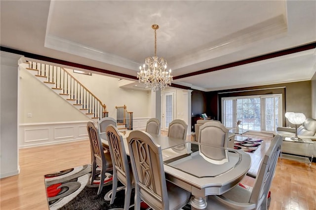 3565 Hickory Branch Trl, Suwanee, GA 30024 - dining area with a chandelier, light wood-style flooring, stairway, crown molding, and a tray ceiling