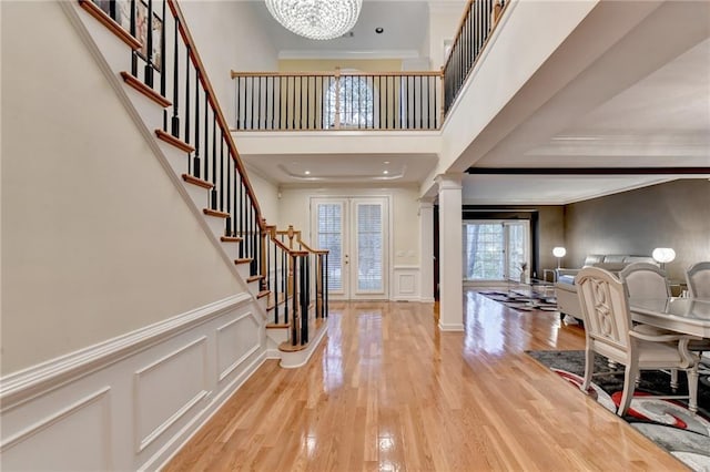 3565 Hickory Branch Trl, Suwanee, GA 30024 - entrance foyer with a chandelier, stairway, decorative columns, crown molding, and wood finished floors