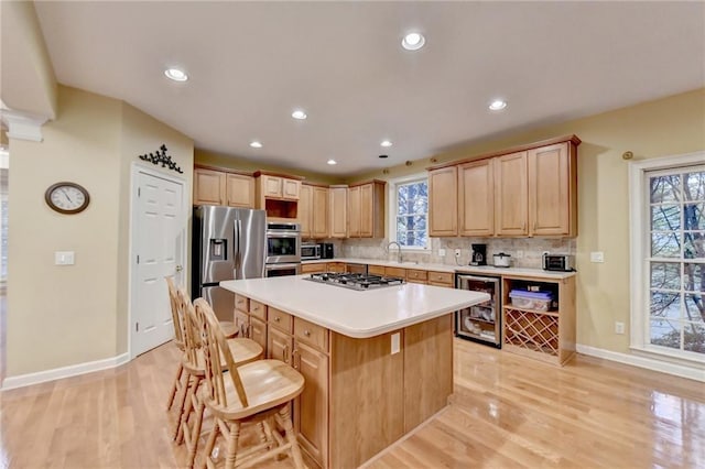 3565 Hickory Branch Trl, Suwanee, GA 30024 - kitchen with wine cooler, stainless steel appliances, a sink, a center island, and a kitchen bar