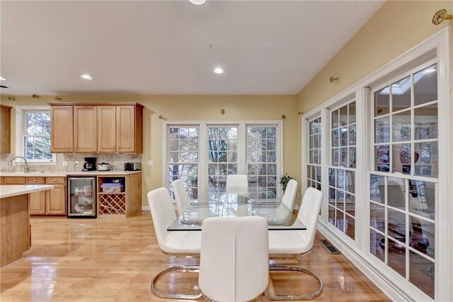 3565 Hickory Branch Trl, Suwanee, GA 30024 - dining space with wine cooler, light wood-style flooring, and recessed lighting