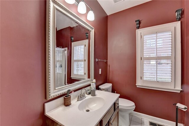 3565 Hickory Branch Trl, Suwanee, GA 30024 - bathroom featuring toilet, tile patterned flooring, vanity, baseboards, and a shower with door