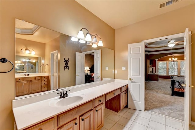 3565 Hickory Branch Trl, Suwanee, GA 30024 - ensuite bathroom featuring tile patterned floors, a chandelier, vanity, and a tray ceiling