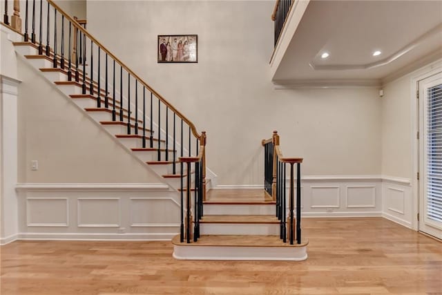 3565 Hickory Branch Trl, Suwanee, GA 30024 - staircase featuring wood finished floors, a decorative wall, a wainscoted wall, recessed lighting, and crown molding