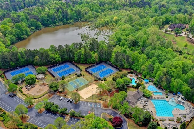 3565 Hickory Branch Trl, Suwanee, GA 30024 - drone / aerial view of a pool, a nearby body of water, and a heavily wooded area
