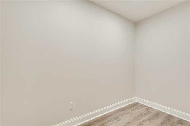 unfurnished room featuring light wood finished floors and baseboards