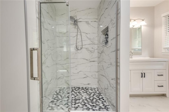 bathroom with marble finish floor, a marble finish shower, and vanity