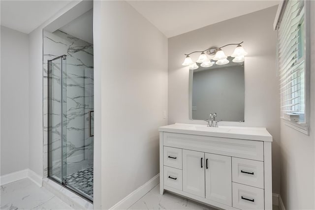 bathroom with marble finish floor, baseboards, vanity, and a marble finish shower