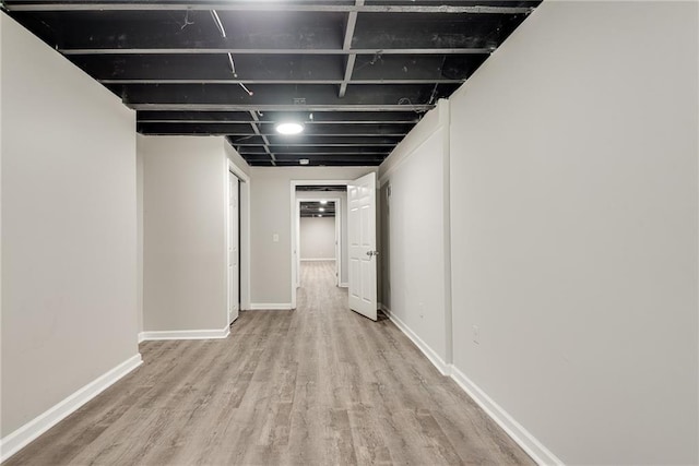 hall featuring baseboards and wood finished floors