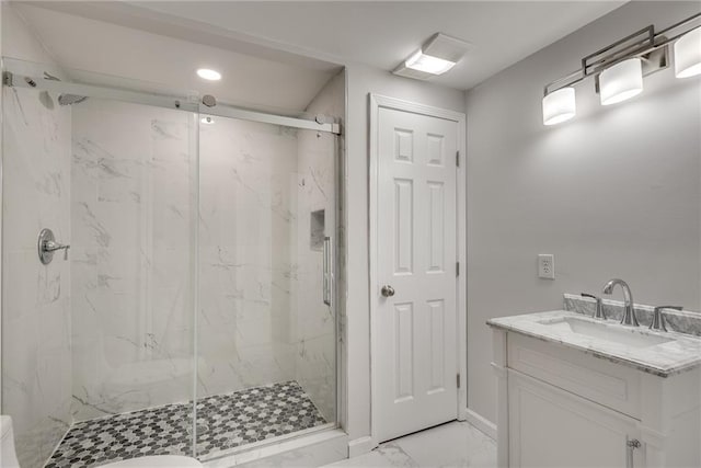 full bathroom featuring marble finish floor, baseboards, vanity, and a marble finish shower