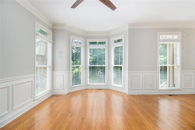 5575 Julian Pl, Atlanta, GA 30342 - spare room featuring a ceiling fan, a wainscoted wall, a decorative wall, light wood-style flooring, and ornamental molding