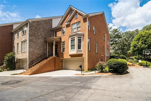5575 Julian Pl, Atlanta, GA 30342 - view of property featuring a garage, driveway, and brick siding