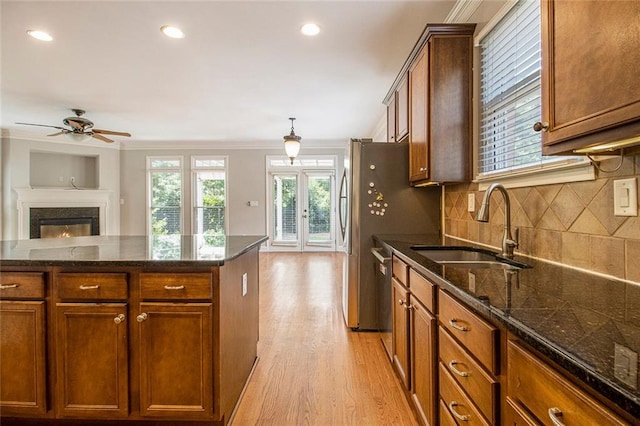 5575 Julian Pl, Atlanta, GA 30342 - kitchen with crown molding, light wood-type flooring, open floor plan, ceiling fan, and decorative backsplash