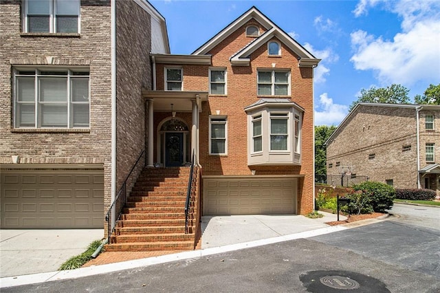 5575 Julian Pl, Atlanta, GA 30342 - multi unit property featuring a garage, concrete driveway, and brick siding