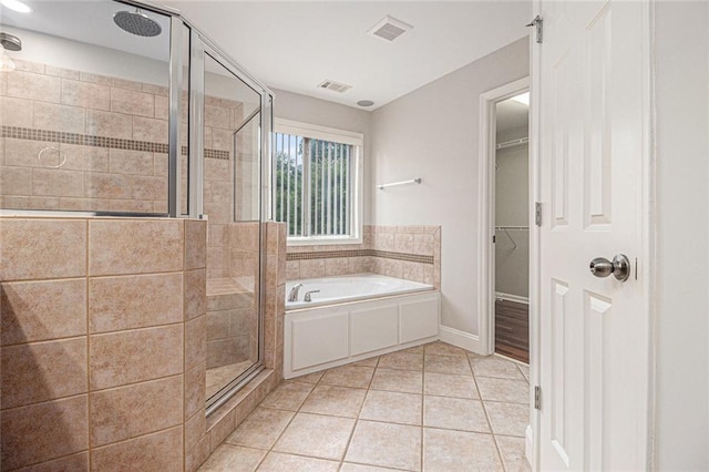 5575 Julian Pl, Atlanta, GA 30342 - bathroom with a stall shower, a garden tub, tile patterned flooring, and a spacious closet