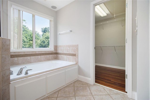 5575 Julian Pl, Atlanta, GA 30342 - full bathroom with a bath, tile patterned floors, and a spacious closet