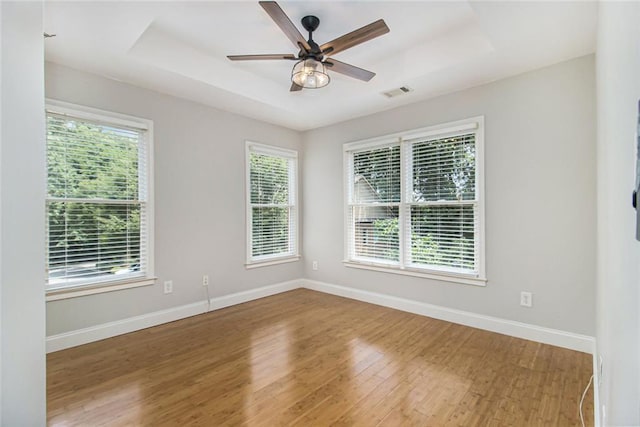 5575 Julian Pl, Atlanta, GA 30342 - spare room featuring plenty of natural light, wood finished floors, and a raised ceiling