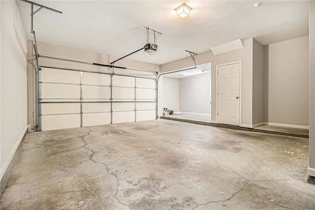 5575 Julian Pl, Atlanta, GA 30342 - garage with a garage door opener and baseboards