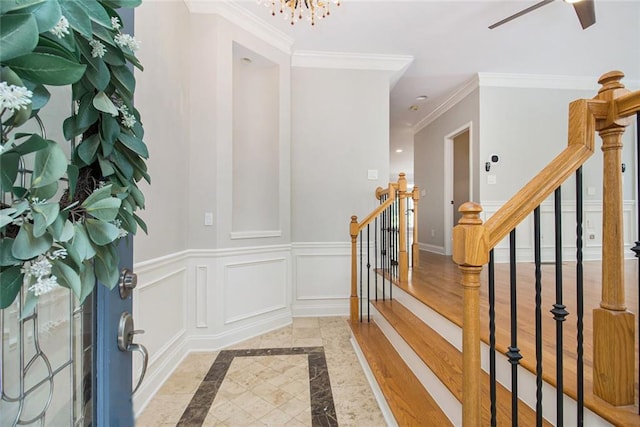 5575 Julian Pl, Atlanta, GA 30342 - foyer featuring inlaid floor details, a chandelier, ornamental molding, and ceiling fan